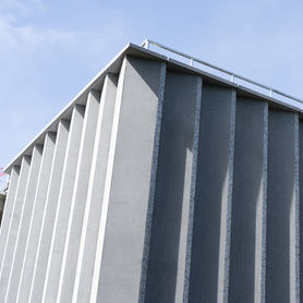 exterior of a modern stone building against a blue sky