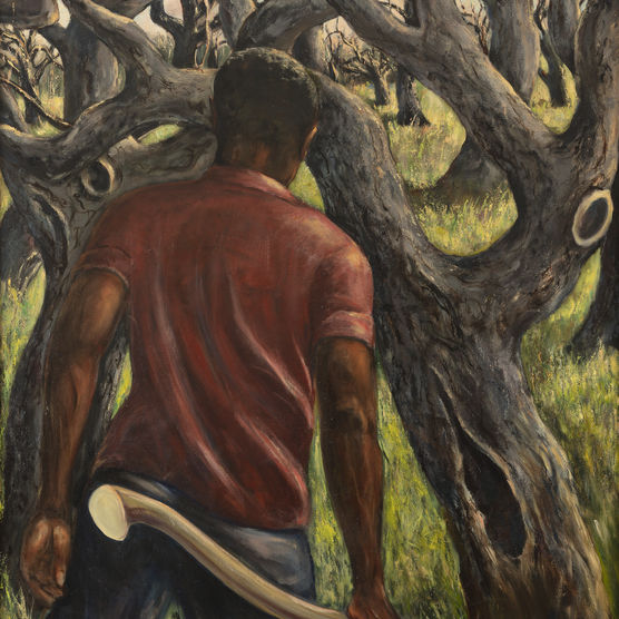 A dark-skinned man faces away from us, in a red shirt, carries an axe, in a grove of twisty trees
