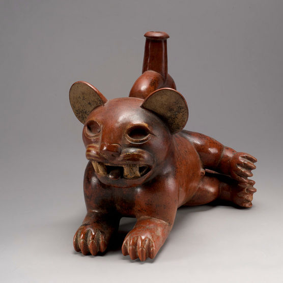 Small, dark red ceramic vessel that resembles a jaguar baring its teeth
