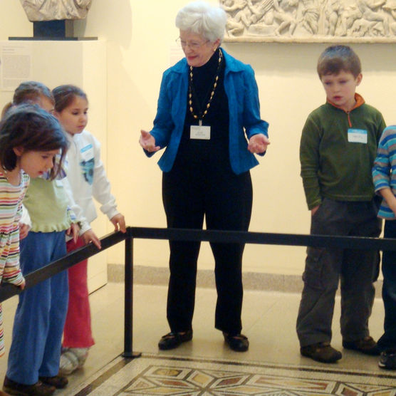 Docent explaining exhibit to group of children