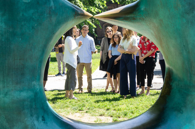 A tour group learns about art on campus.