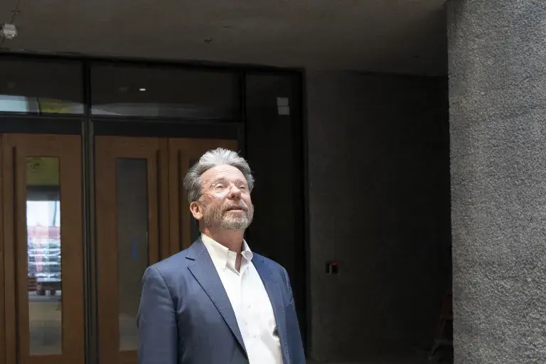 Museum Director James Steward looking up in the new Museum entry way with the main doors in the background.