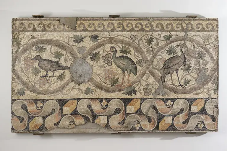 Ancient mosaic depicting birds surrounded by vegetal and geometric motifs.
