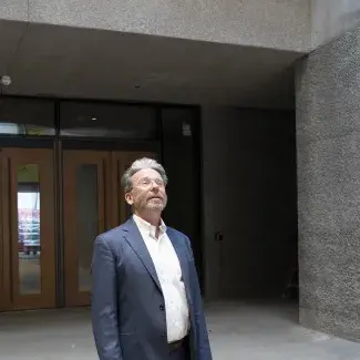 Museum Director James Steward looking up in the new Museum entry way with the main doors in the background.