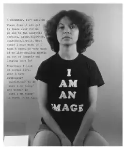 Black-and-white photograph of a sitting woman wearing a black t-shirt that says "I am an image," and superimposed text appears on the photo.