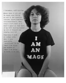 Black-and-white photograph of a woman sitting in a tshirt that says "I am an image."